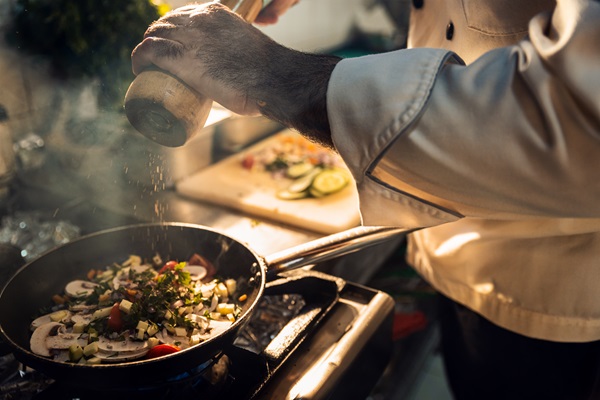 Chef turns pepper mill to season vegetables